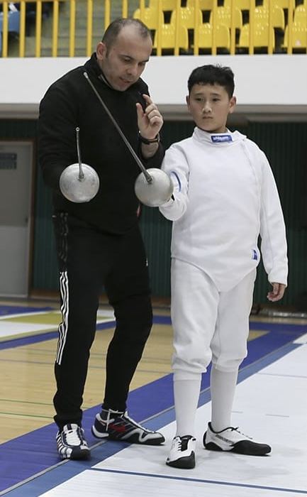Coach Yousef teaching a fencer